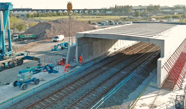 1) The skew-bridge is sited where the main north and southbound carriageways cross a rail freight line